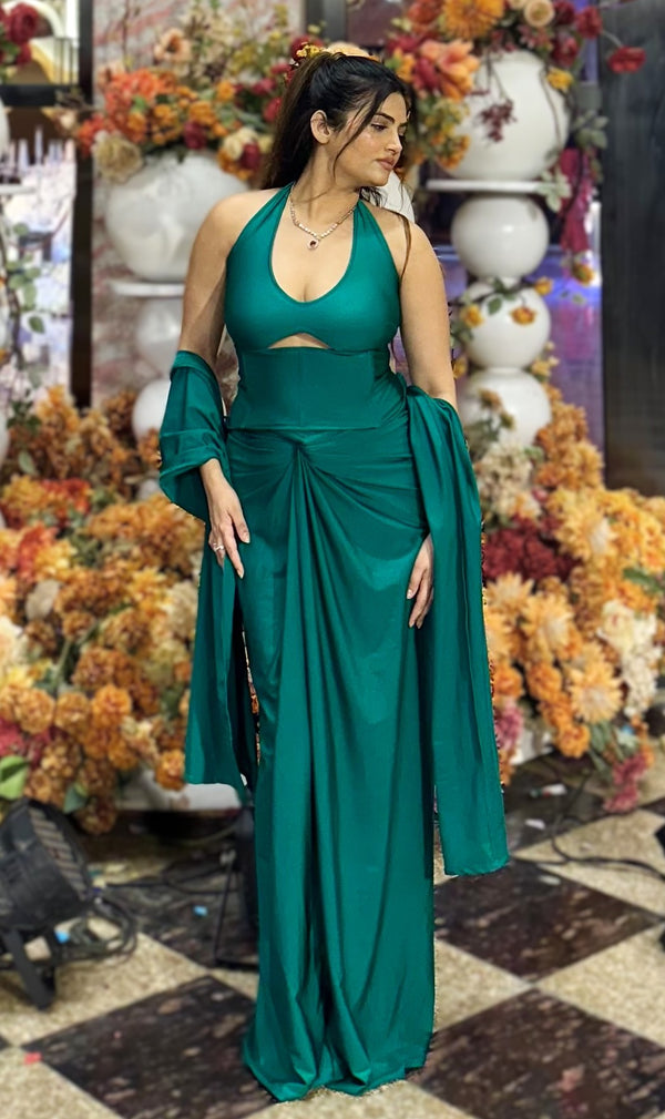 rooshy Mehraz Emerald Drape Set - model in emerald green halter drape set with shawl front view floral backdrop