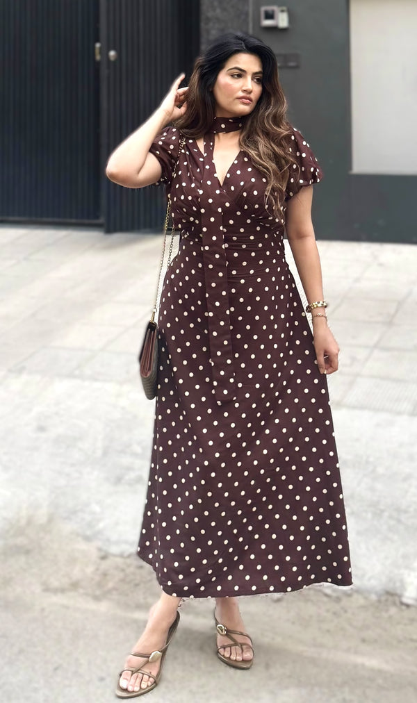 rooshy brown polka dot choker midi dress - model hand in hair with cross-body bag styled look urban backdrop