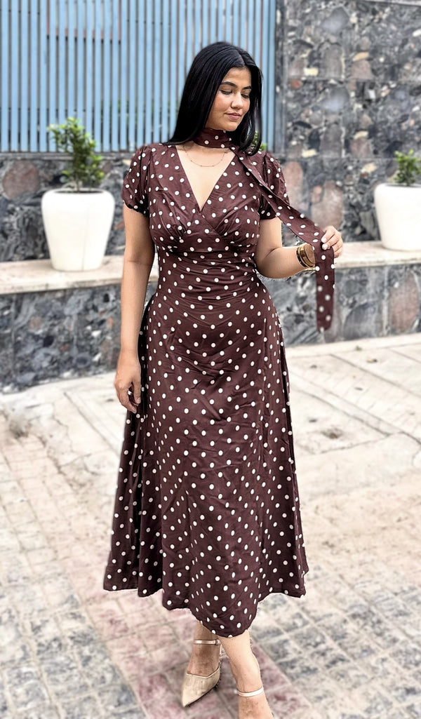 rooshy brown polka dot choker midi dress - model looking down holding scarf showing A-line silhouette